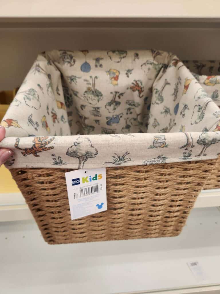 Wicker baby bassinet with Disney-themed fabric lining for infants.