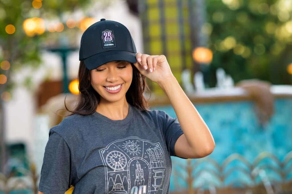 Woman wearing Disney California Adventure 25th anniversary cap at the park.