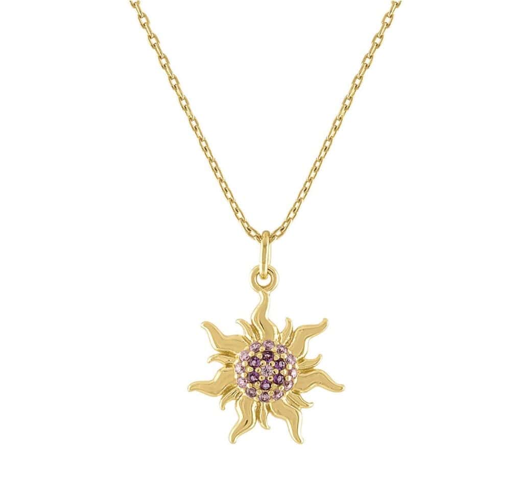 Gold sunburst pendant necklace with purple gemstones, elegant jewelry piece.