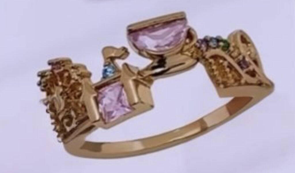 Disney-themed pink gemstone gold ring with detailed design and sparkling embellishments.