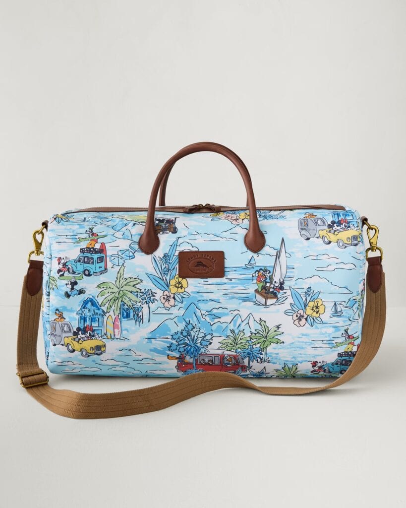 Disney cruise bag with tropical and nautical print, brown leather handles, and adjustable shoulder s.