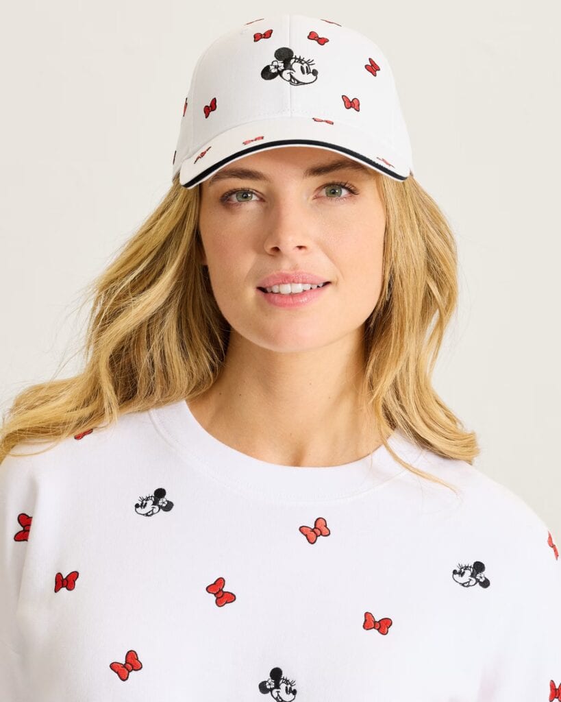 White Minnie Mouse cap and T-shirt with red bows and black mouse prints.