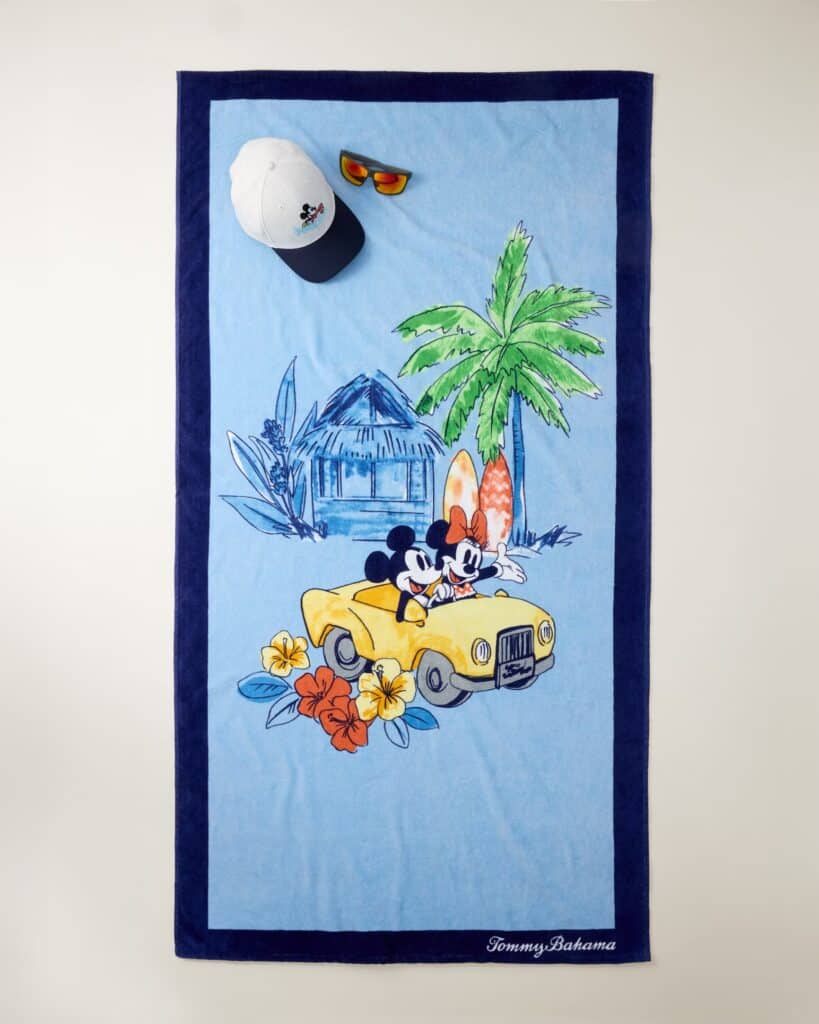 Mickey Mouse and friends on a beach towel with tropical scenery.