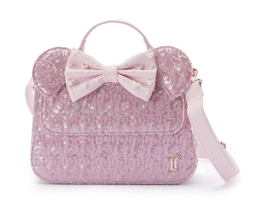 Pink sequin Disney handbag with bow, pearl details, and adjustable strap.