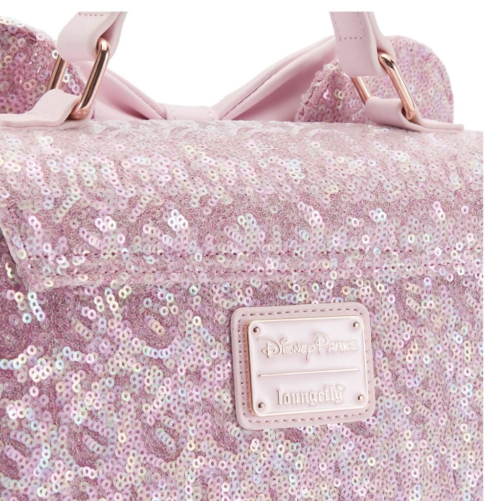 Pink sequin Disney Parks Loungefly bag with adjustable straps.