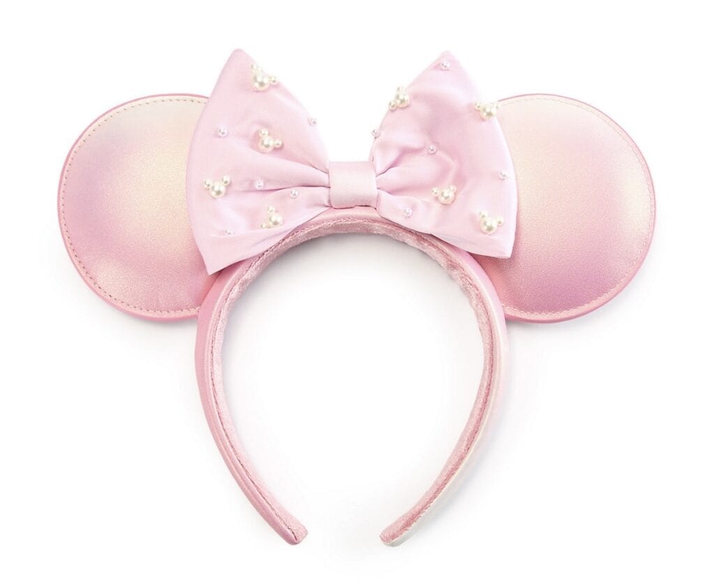 Pink Minnie Mouse ears headband with pearl-embellished bow, perfect for Disney fans.