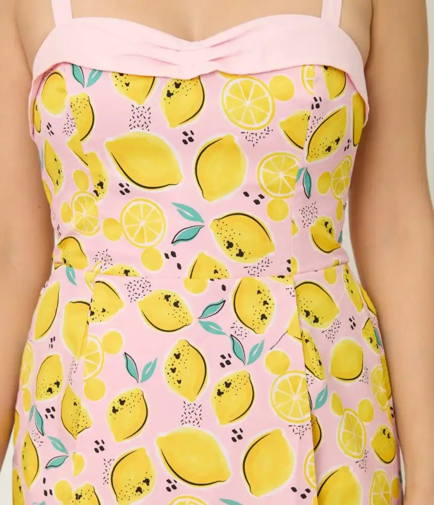 Themed dress with pink accents and playful fruit pattern.