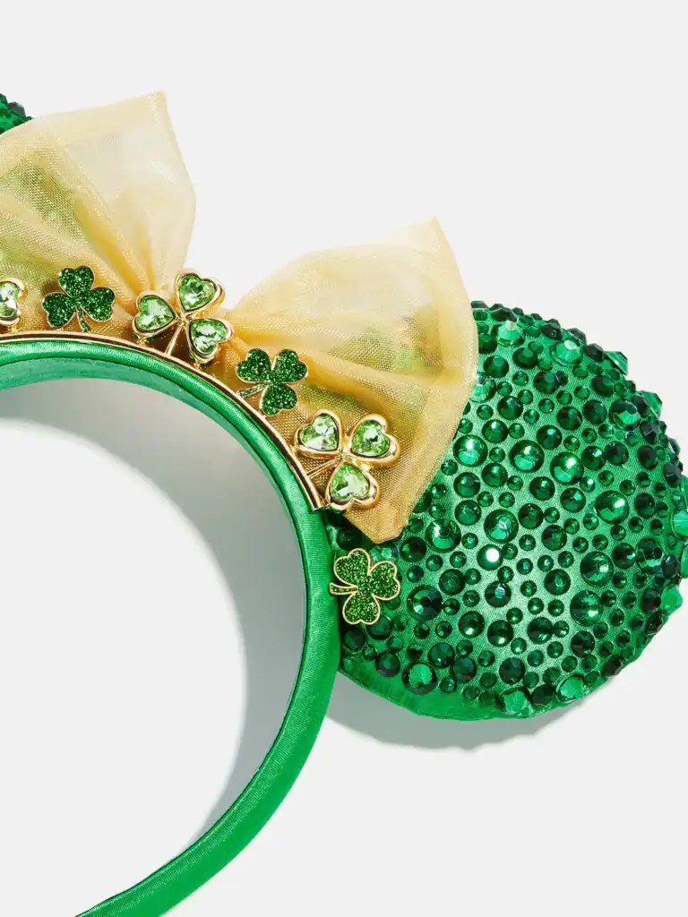 Green Mickey Mouse ears headband decorated with shamrocks and a bow for St. Patrick's Day.