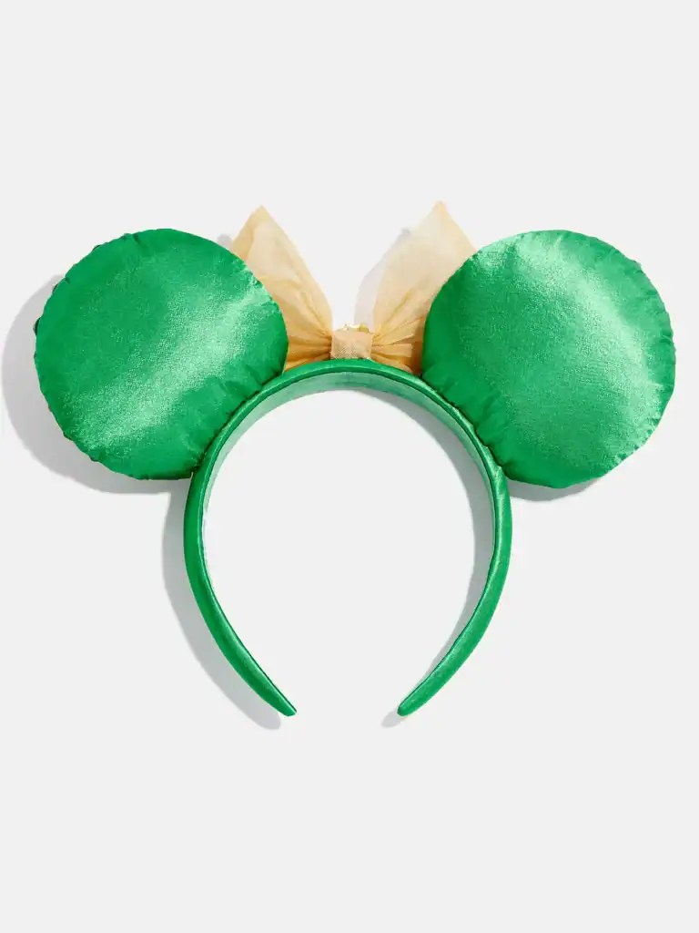 Green Minnie Mouse ears headband with beige bow, ideal for Disney-themed costumes and events.