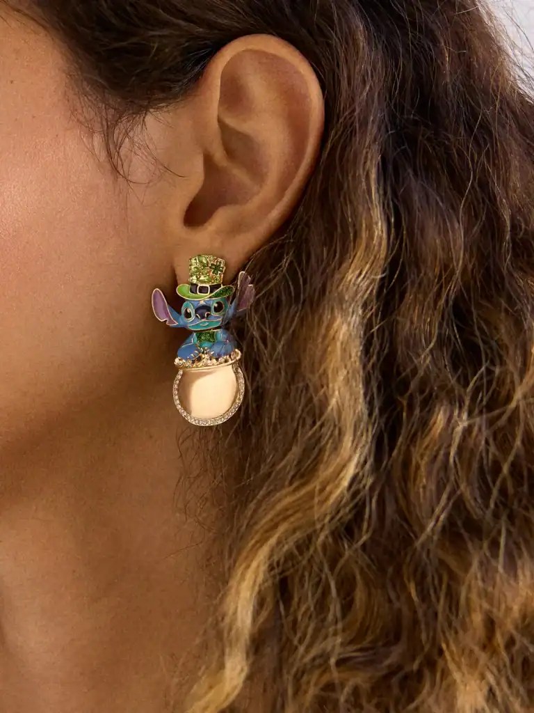 Close-up of Disney Stitch earring with charm and vibrant colors on woman's ear.
