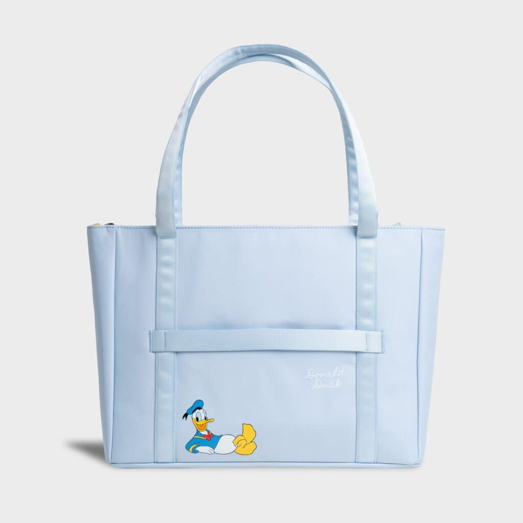Light blue Donald Duck tote bag with front pocket and embroidered Donald Duck image.