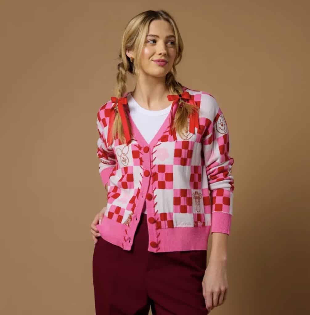 Stylish pink and red checkered cardigan with Disney-inspired patches for a trendy look.