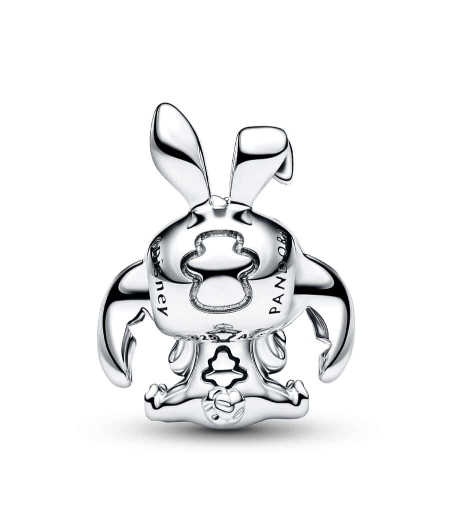 Shaped charm with intricate cutout details.