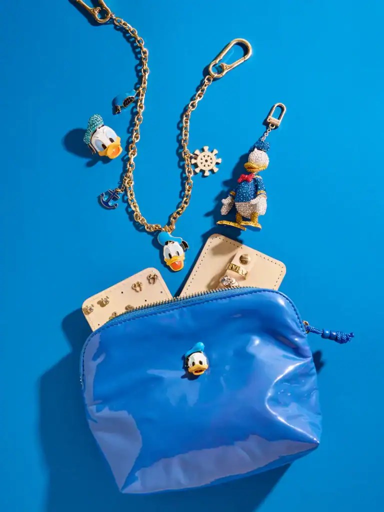 Bright blue Disney-themed bag with Donald Duck charms and accessories.