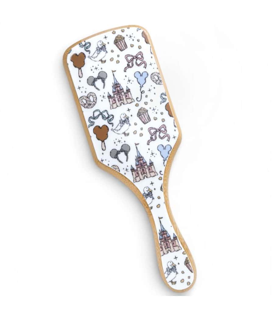 Disney princess themed hairbrush with castle and character designs.
