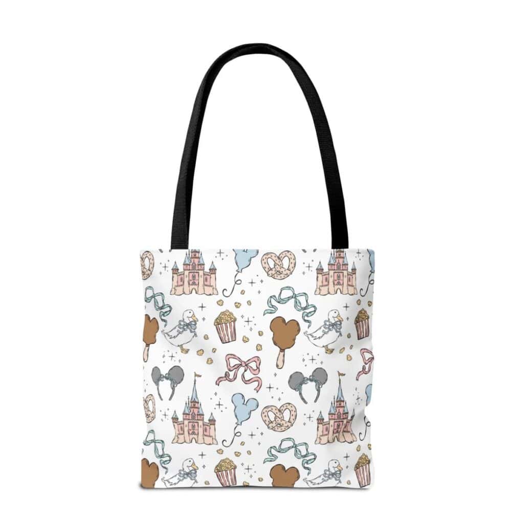 Disney princess themed tote bag with castles, cupcakes, and hearts. Perfect for Disney fans and fash.