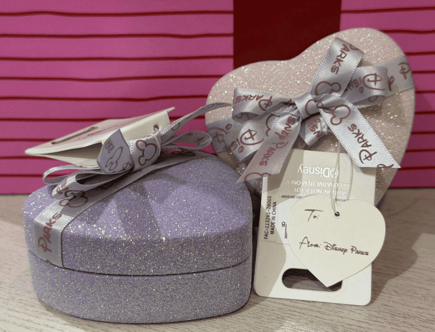 Sparkling Loungefly heart-shaped mystery bag charms with Disney-themed ribbons for Disney fans.