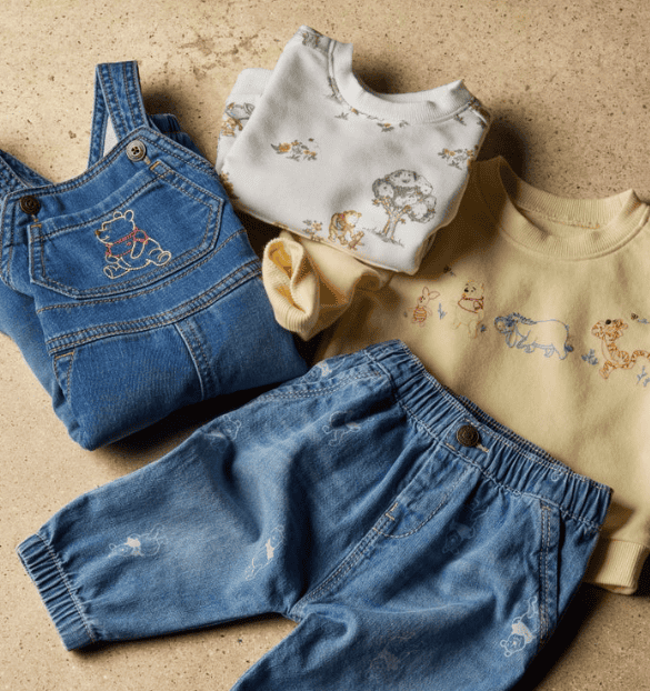 Disney Winnie the Pooh themed children's clothing including denim overalls and cozy sweatshirts.