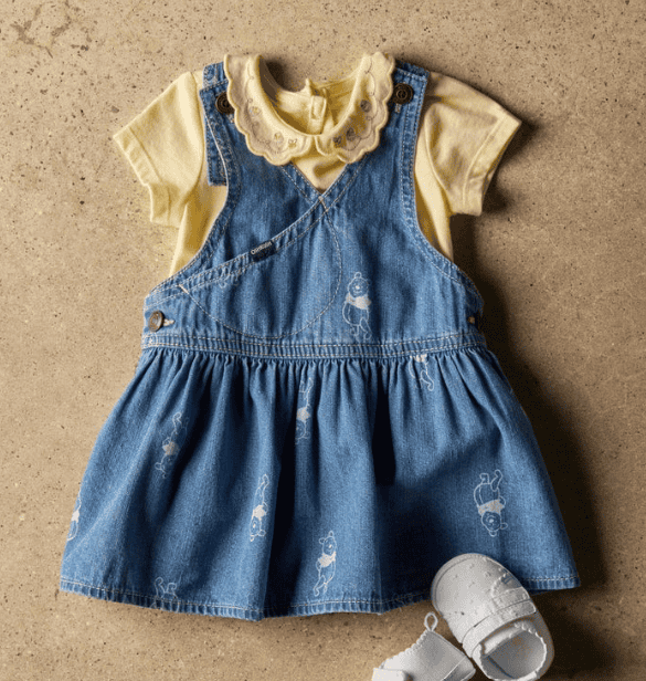 Winnie the Pooh baby dress with denim overalls and yellow top, celebrating 100 years of Winnie the P.
