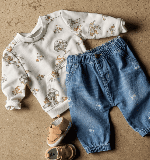 Adorable Winnie the Pooh themed children's outfit featuring a printed sweatshirt and denim shorts.