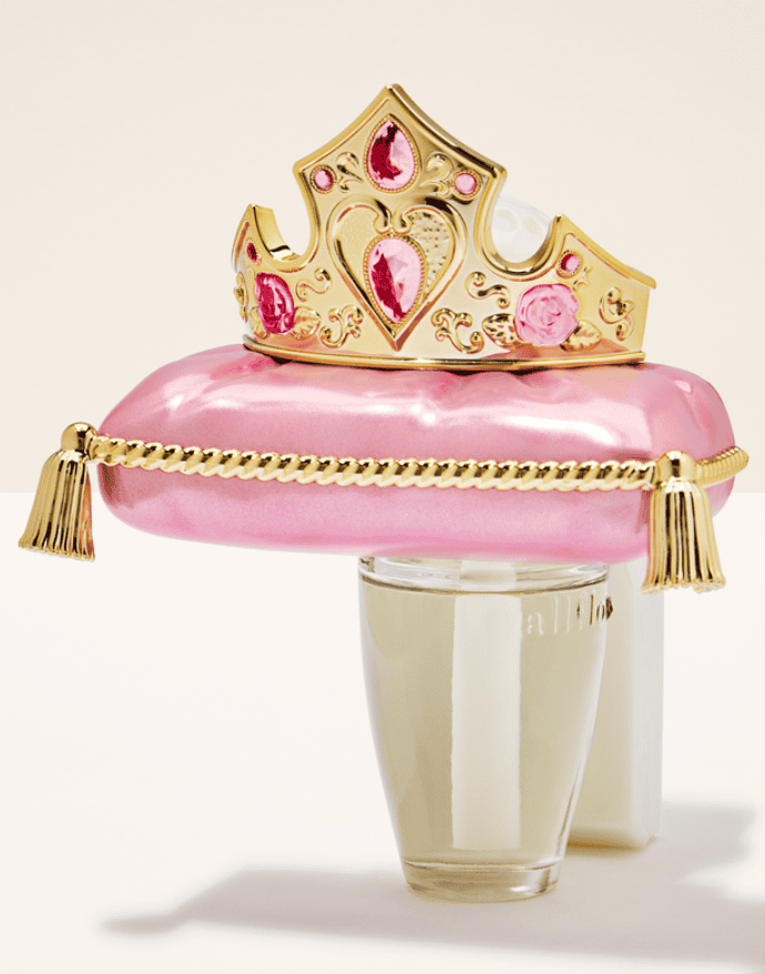Princess crown with pink satin pillow and gold chain, perfect Disney-inspired accessory.