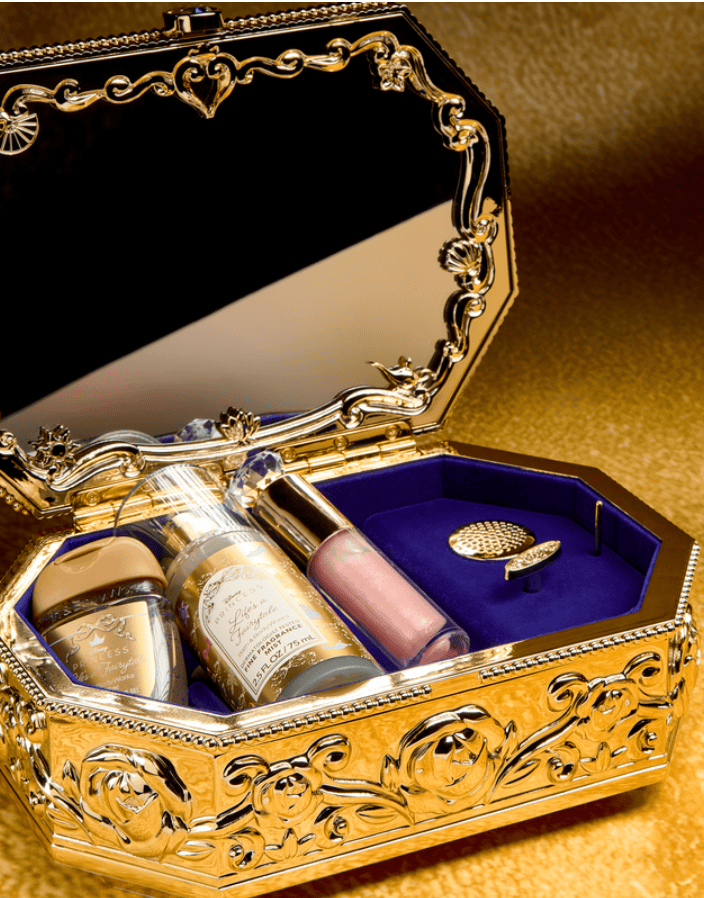 Disney jewelry box with perfume bottles and a ring inside.