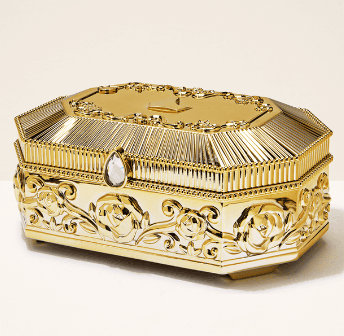 Luxurious gold jewelry box with floral patterns and gemstone embellishments, perfect for Disney fash.