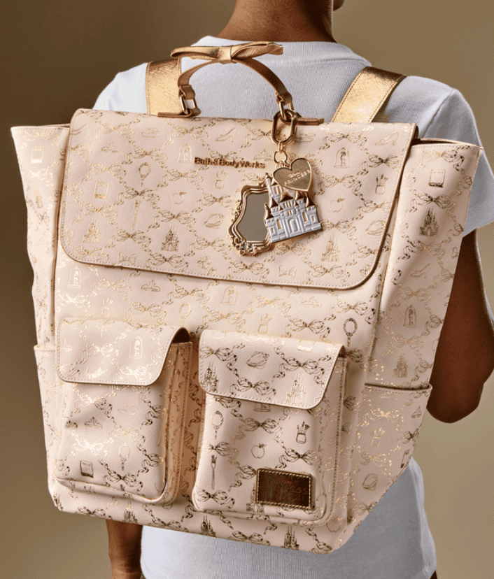 Backpack featuring Disney-themed print and gold hardware, perfect for Disney fans.