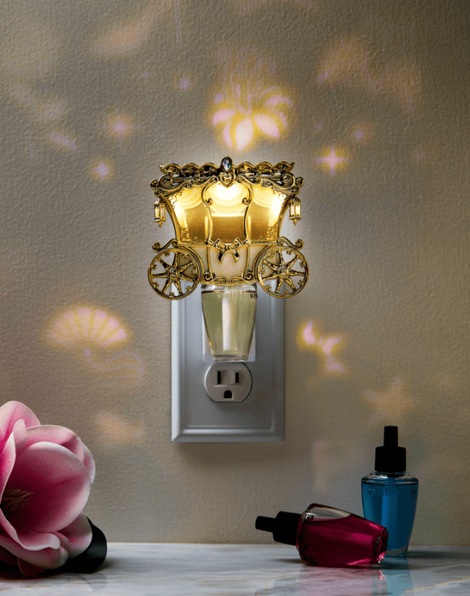 Night light shaped like a fairy tale carriage with golden details and sparkling accents.