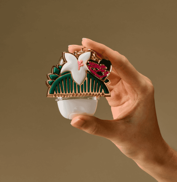 An elegant hair clip featuring a white swan, pink heart, and green decorative elements, perfect for.