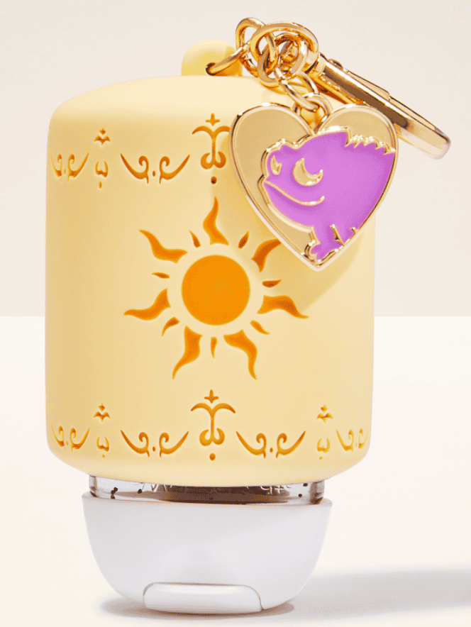 Sun and moon Disney-themed AirPods case with heart charm accessory.