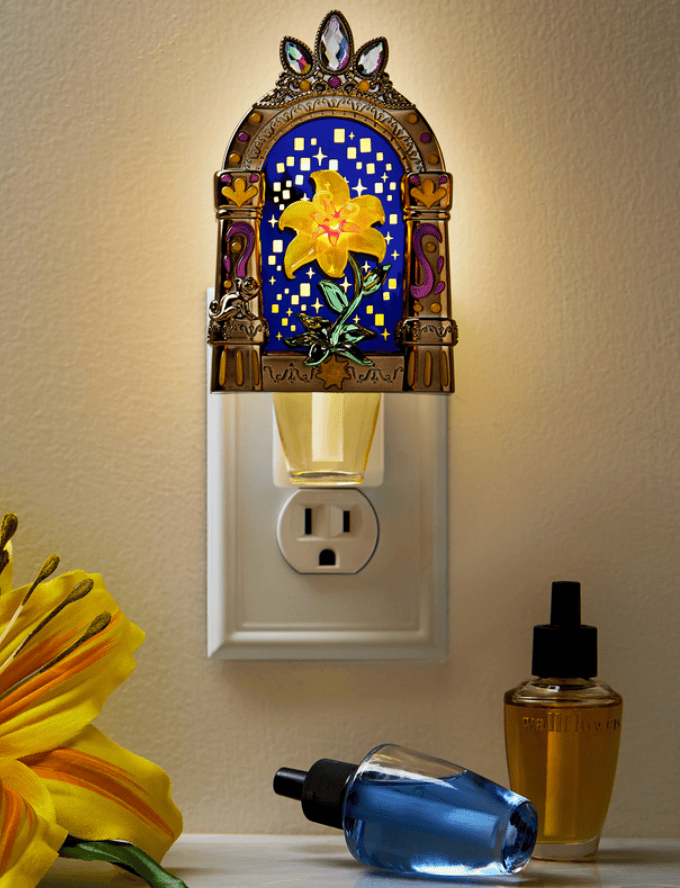 Nightlight with stained glass floral motif, illuminating a wall outlet.