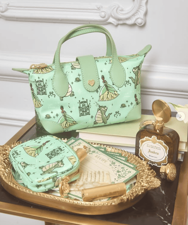 Stylish mint green Disney-themed handbag with princess and castle prints, perfect for Disney fans an.