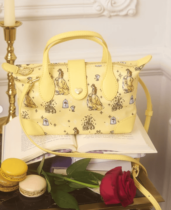Yellow Disney princess handbag with illustrations, macarons, and a red rose.
