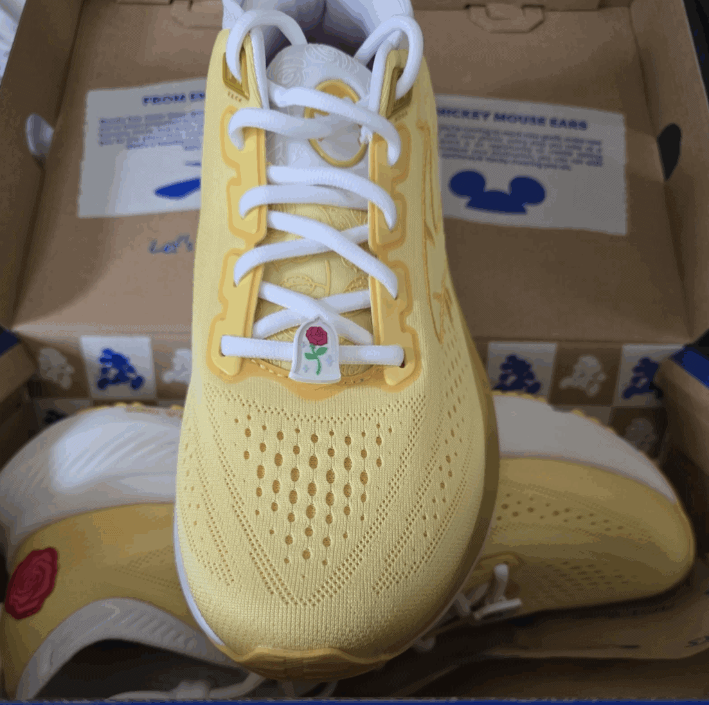 Yellow Disney sneaker with lace-up closure and rose detail, perfect for Disney fans and casual wear.