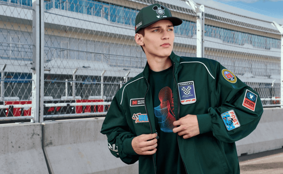 Young woman in stylish racing jacket at the race track.