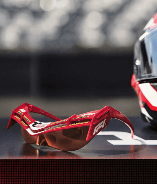 Racing sunglasses with orange lenses and red frame for motorsport enthusiasts.