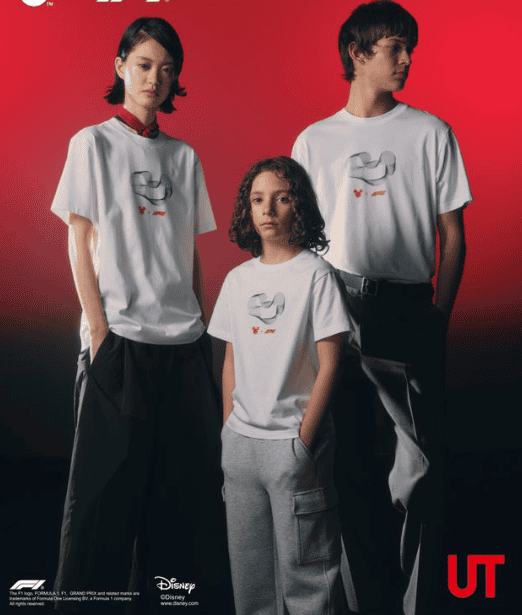 Family wearing matching Disney-themed T-shirts against red background.