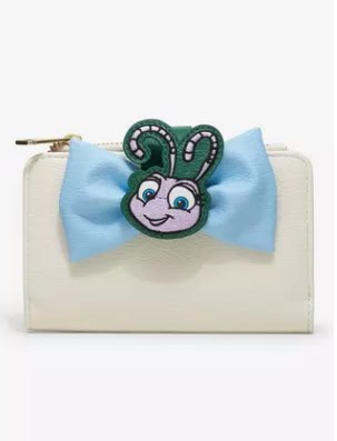 Disney-themed wallet featuring a bow and a character badge with a playful face.