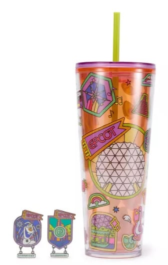 Themed tumbler with colorful stickers and a green straw, perfect for fans of Disney fashion and acce.