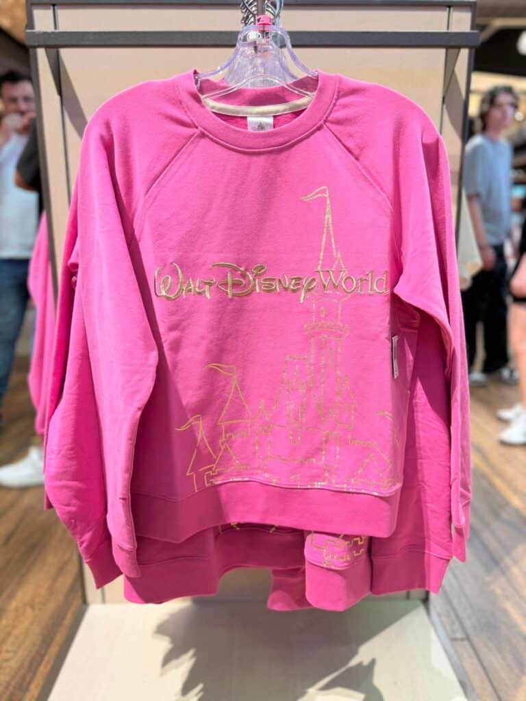 Pink Walt Disney World sweatshirt with gold logo, casual Disney fashion piece.