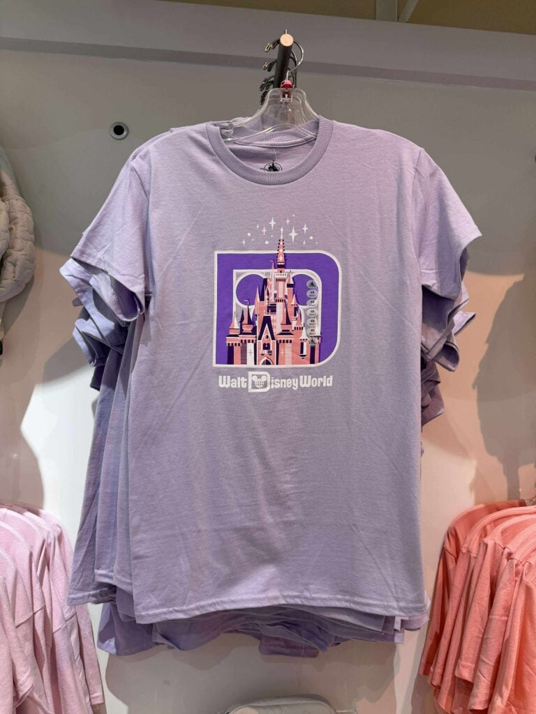 Light purple Disney castle T-shirt with "Walt Disney World" logo, perfect for Disney fans.