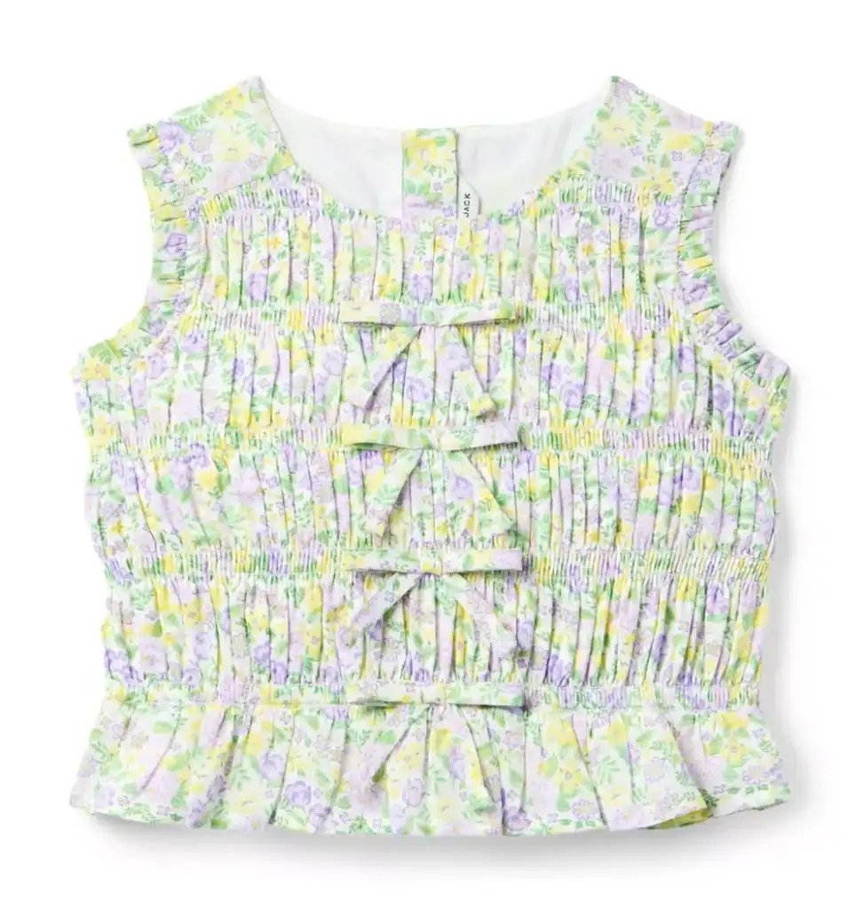 Cute floral girls' top with ruffles and bow details, perfect for Easter and spring outings.