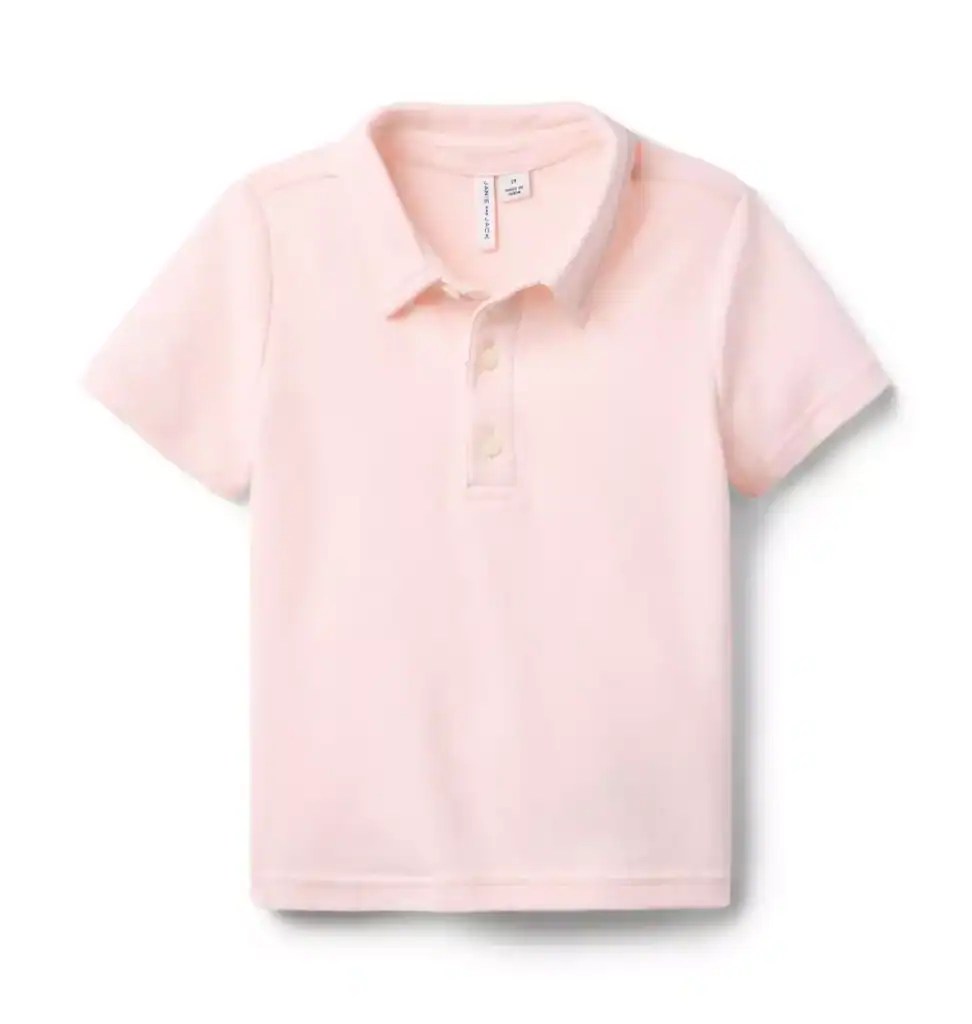 Soft pink children's polo shirt with collar and buttons, perfect for spring and Easter outfits.
