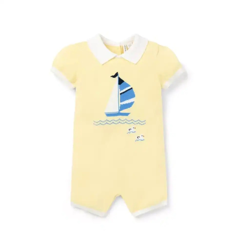Adorable yellow baby romper featuring a navy blue sailboat and seagull print, perfect for Easter and.