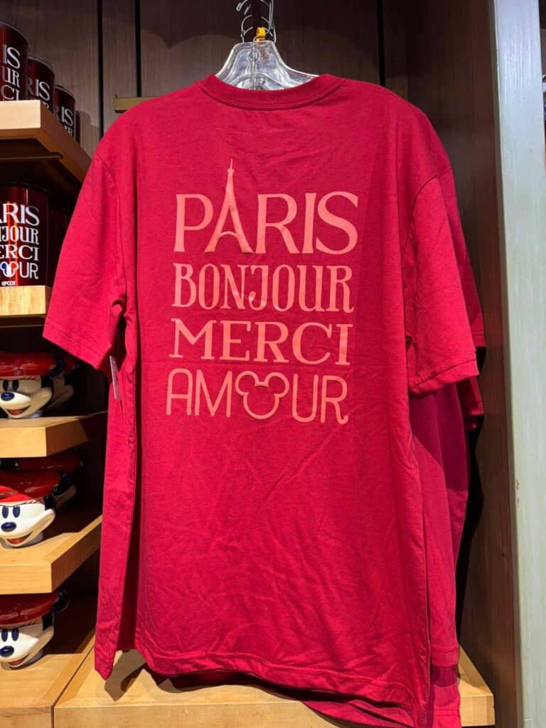 Red Paris-themed T-shirt with Disney-inspired text and Mickey Mouse logo.