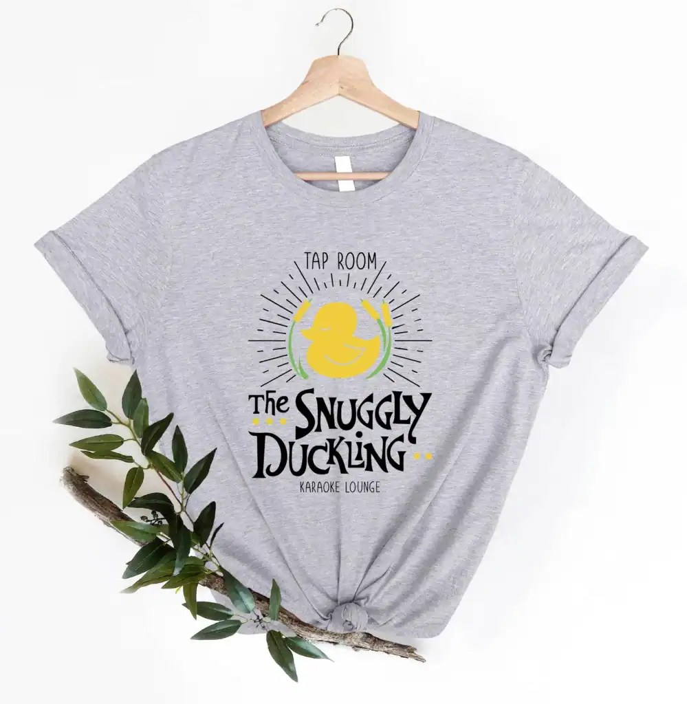 Gray Snuggly Duckling shirt with "Tap Room" and "Karaoke Lounge" text, casual style.