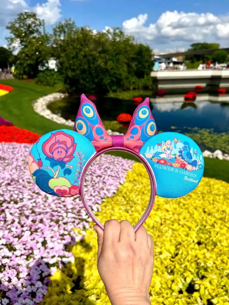 Minnie Mouse ears headband with colorful butterfly and floral designs, perfect for Disney fans.