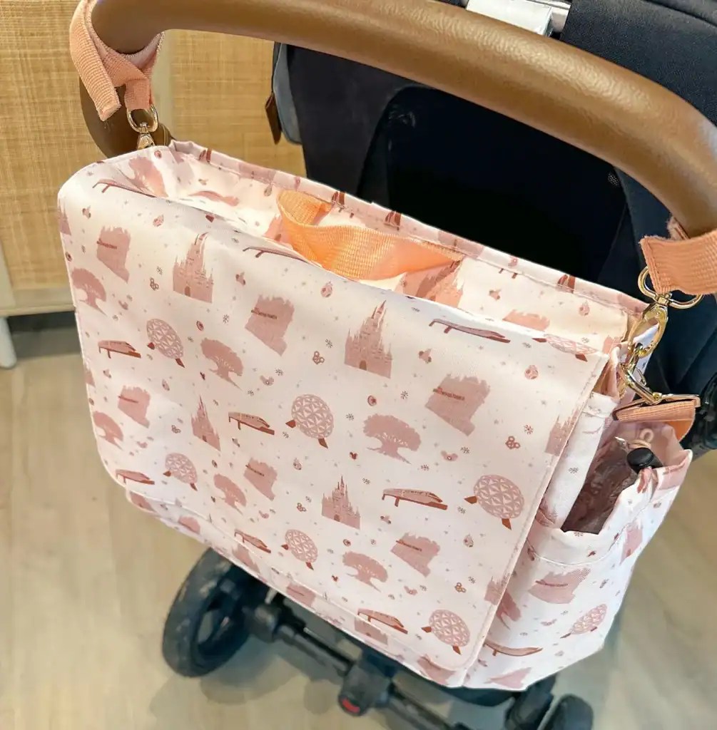 Stylish pink castle patterned stroller organizer for Disney fans.