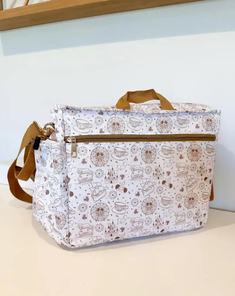 Laptop bag with Disney-inspired print and brown accents.